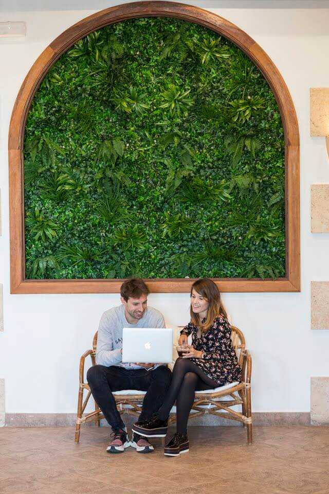 Two people working under an arched window