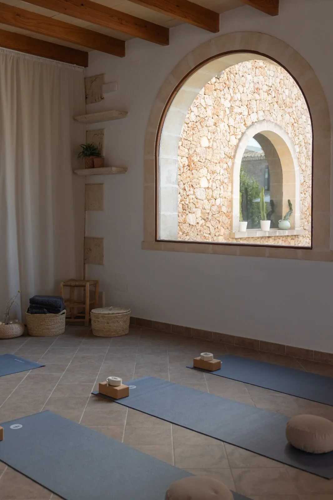 Empty yoga room with arched window